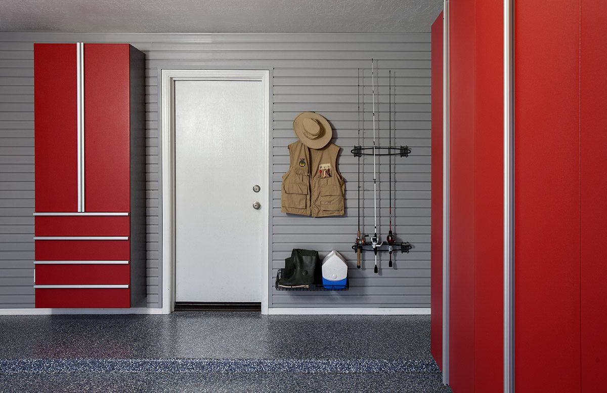 A garage with red cabinets and a hat rack.