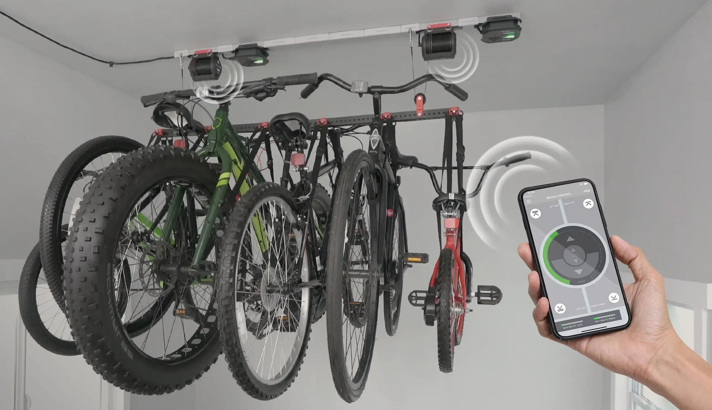 A person is using a phone to control a bike rack in a garage.